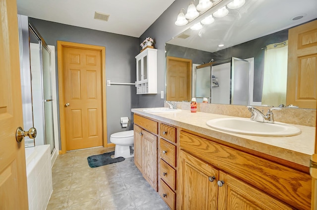 bathroom featuring tile patterned flooring, vanity, toilet, and walk in shower