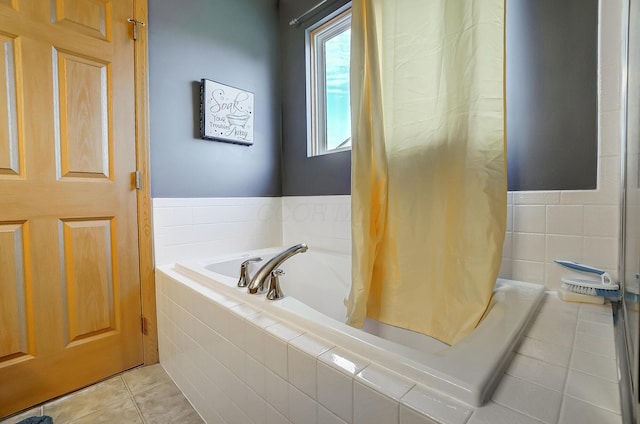 bathroom with tile patterned floors and tiled bath