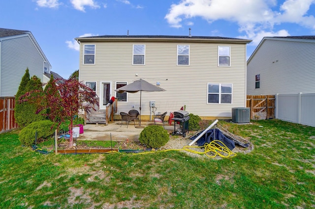 back of property featuring a yard, cooling unit, and a patio area