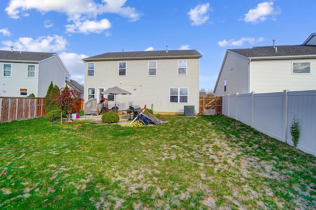 back of house featuring central AC, a yard, and a patio