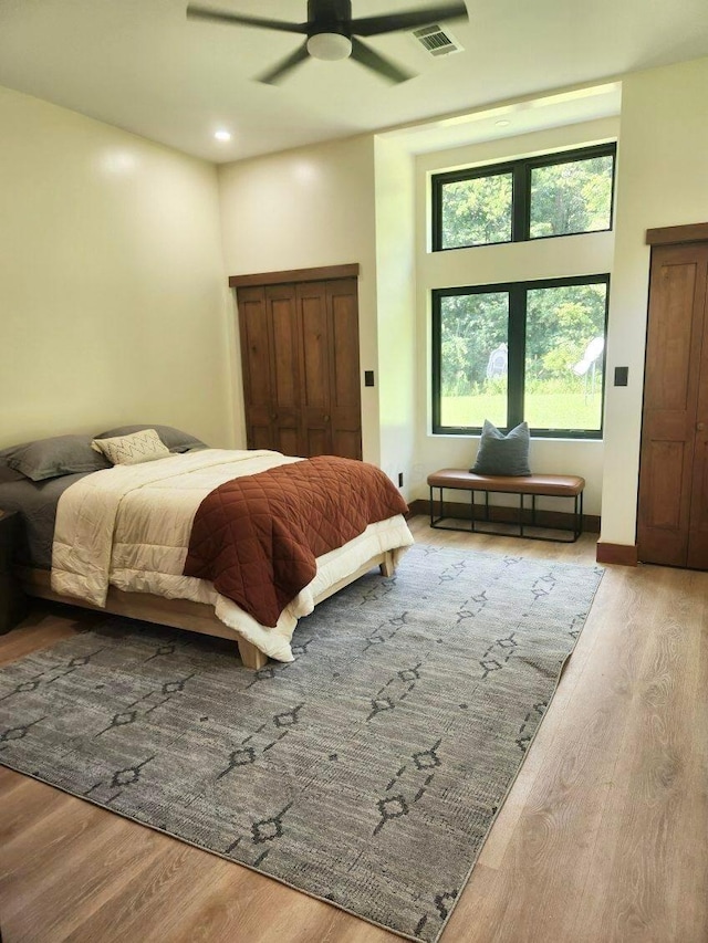 bedroom with light hardwood / wood-style flooring and ceiling fan