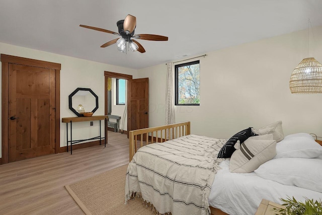 bedroom featuring ceiling fan and light hardwood / wood-style flooring