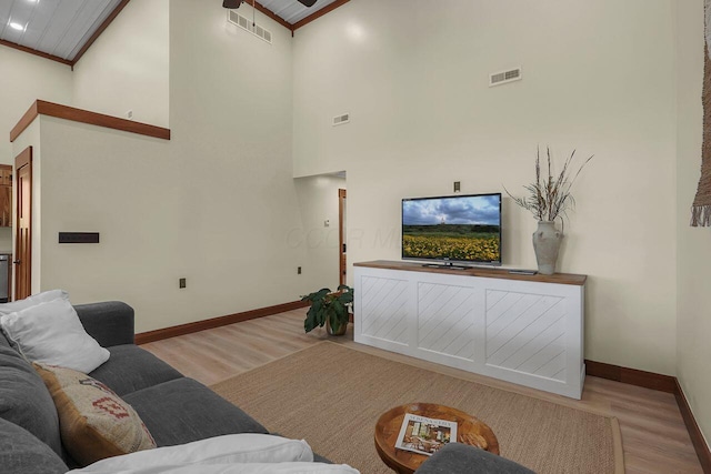 living room with ornamental molding, ceiling fan, high vaulted ceiling, wooden ceiling, and light hardwood / wood-style floors