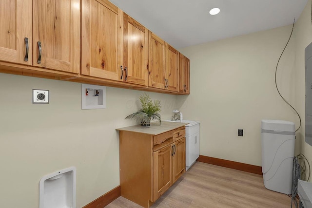 laundry area with cabinets, washer hookup, light wood-type flooring, and sink