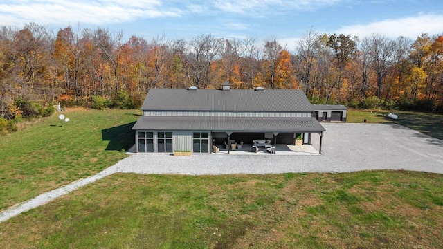 back of house featuring a yard and a patio