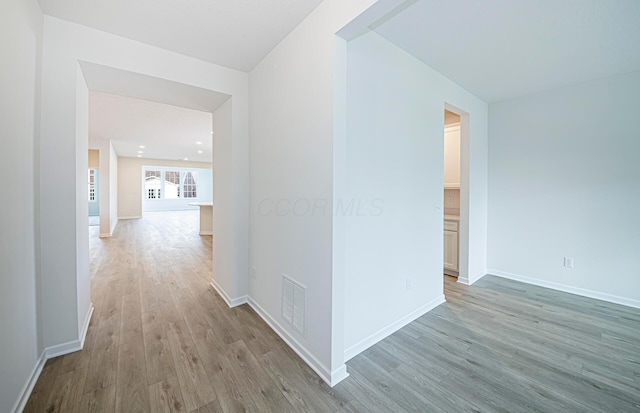 hall with light hardwood / wood-style flooring