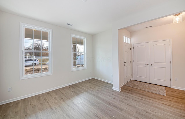 entrance foyer featuring light hardwood / wood-style flooring and a wealth of natural light