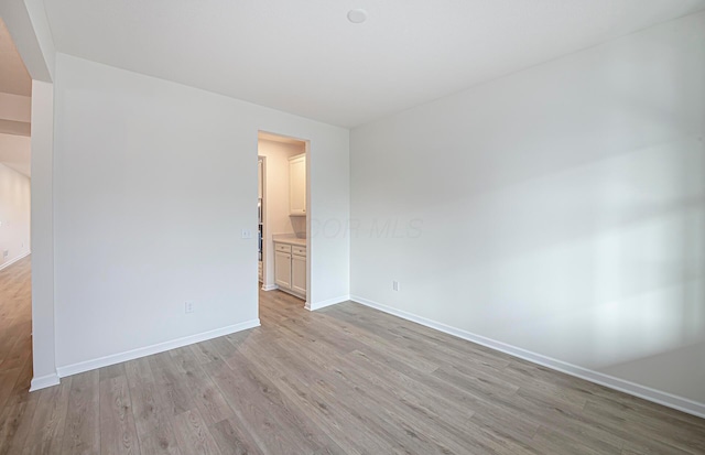 spare room with light wood-type flooring