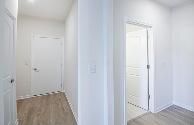 hall with light hardwood / wood-style floors