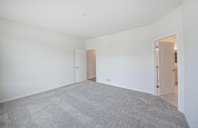 empty room featuring light colored carpet