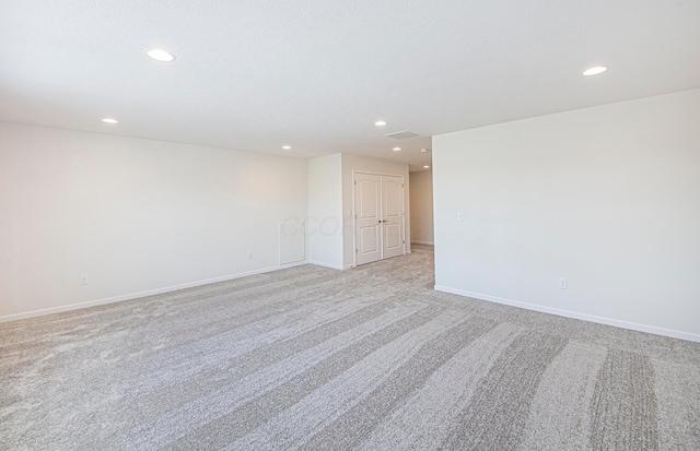 spare room with light colored carpet