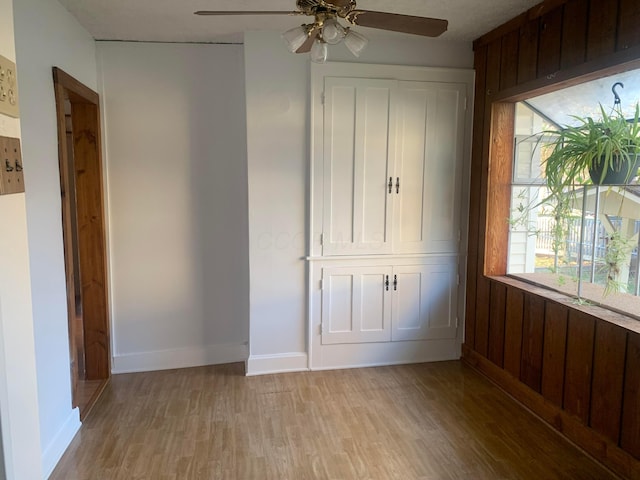 unfurnished bedroom with light hardwood / wood-style floors, multiple windows, and ceiling fan