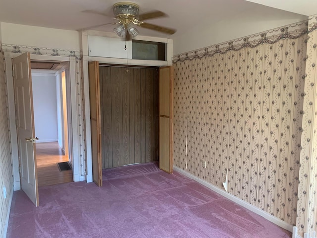 unfurnished bedroom featuring ceiling fan and carpet floors