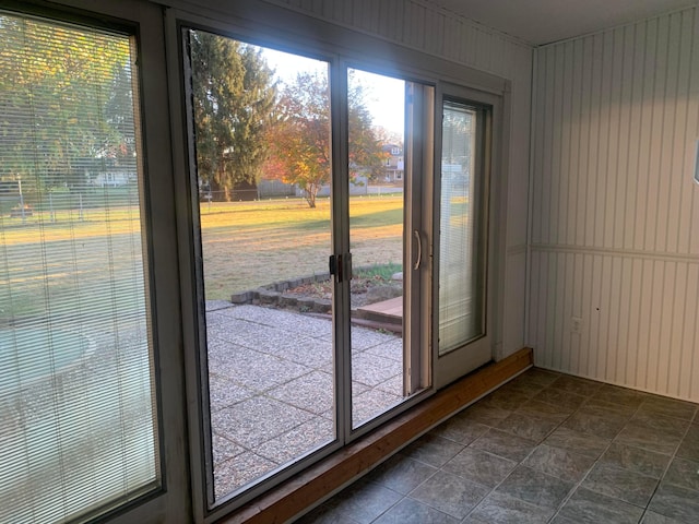 doorway featuring wooden walls