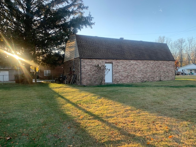 view of side of home with a yard