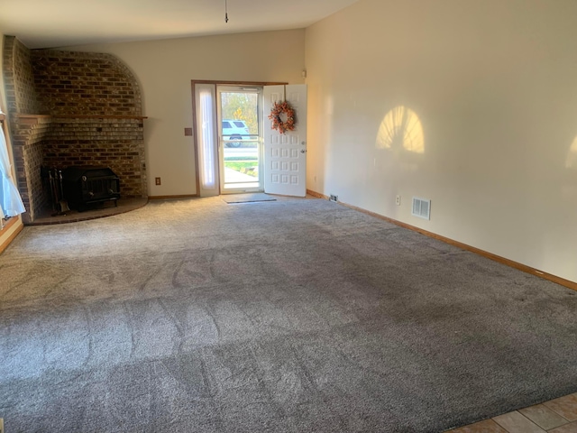 unfurnished living room with light colored carpet and lofted ceiling