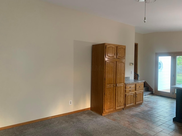 kitchen featuring light carpet