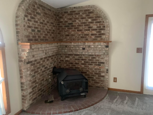 room details featuring carpet and a wood stove