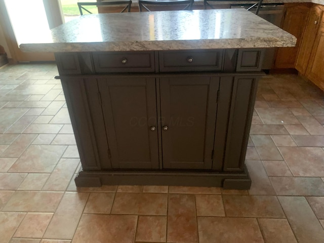 kitchen featuring dark brown cabinetry and a kitchen island