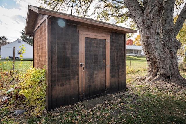 view of shed featuring fence