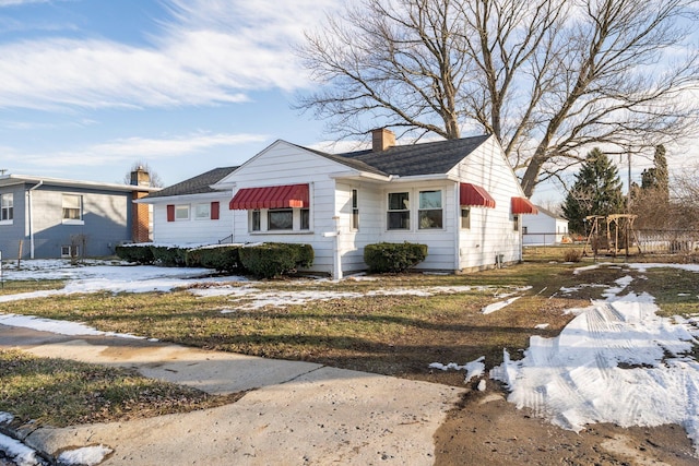 bungalow-style house featuring a chimney