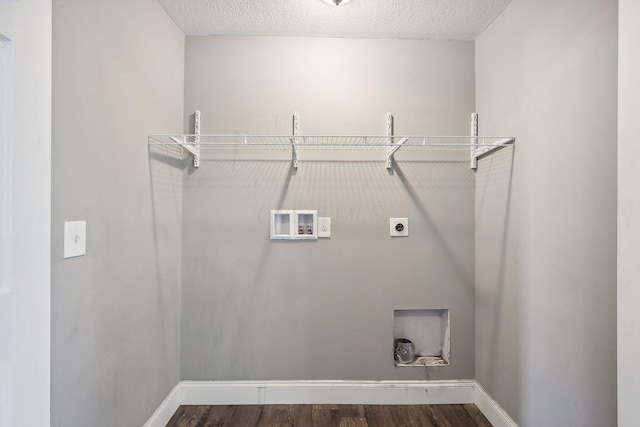 clothes washing area featuring hookup for an electric dryer, washer hookup, a textured ceiling, and dark hardwood / wood-style floors