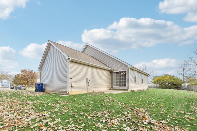 rear view of property with a lawn and a patio area