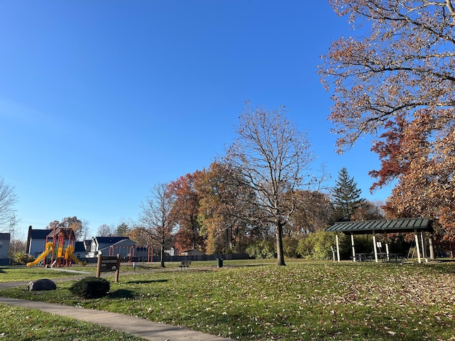 view of property's community with a gazebo, a playground, and a yard