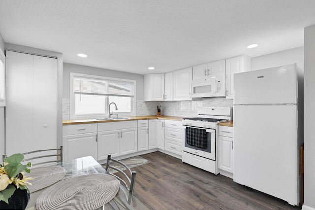 kitchen featuring decorative backsplash, white appliances, dark wood-type flooring, sink, and white cabinetry