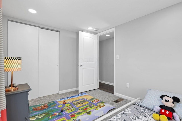 bedroom with carpet and a closet