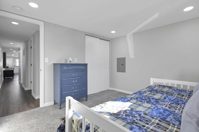 bedroom featuring electric panel, a closet, and dark hardwood / wood-style floors