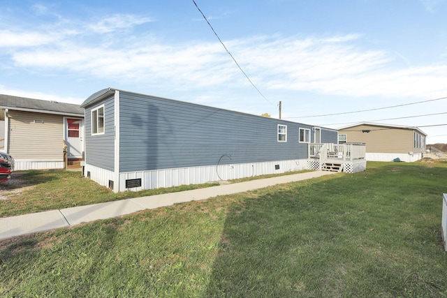 view of property exterior featuring a lawn and a wooden deck