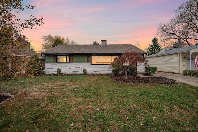 ranch-style house featuring a yard