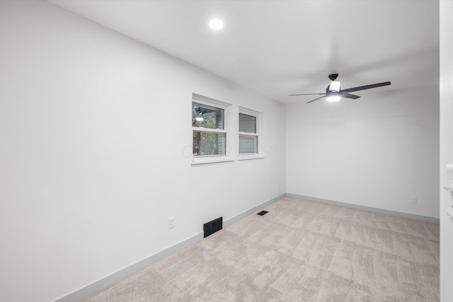 unfurnished room with ceiling fan and light colored carpet