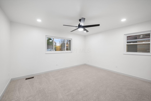 empty room featuring carpet flooring and ceiling fan