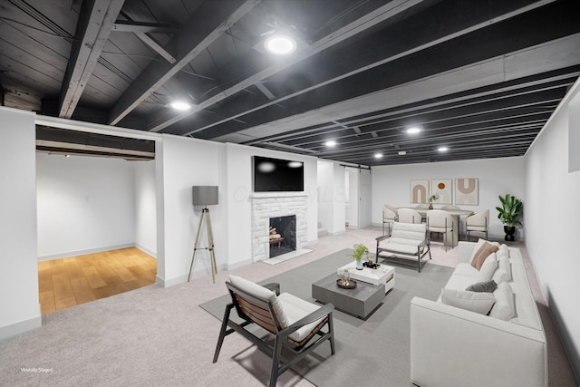 living room featuring a fireplace, beamed ceiling, and light hardwood / wood-style floors