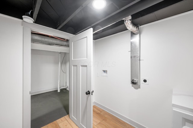 interior space with washer hookup, hookup for an electric dryer, and hardwood / wood-style flooring