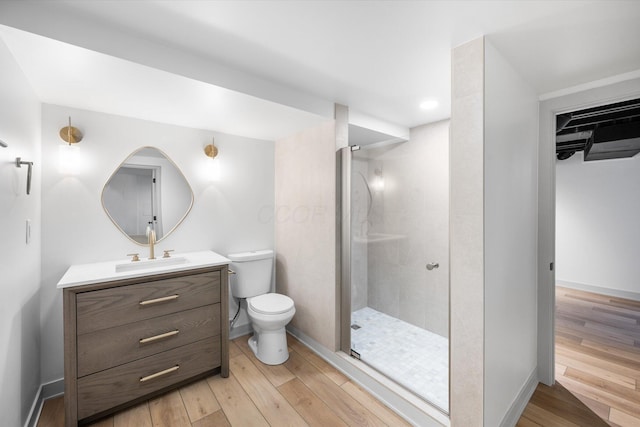 bathroom with vanity, toilet, wood-type flooring, and walk in shower