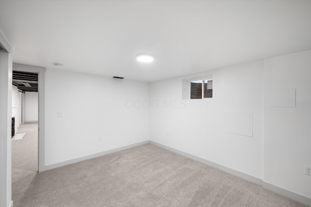 basement featuring light carpet