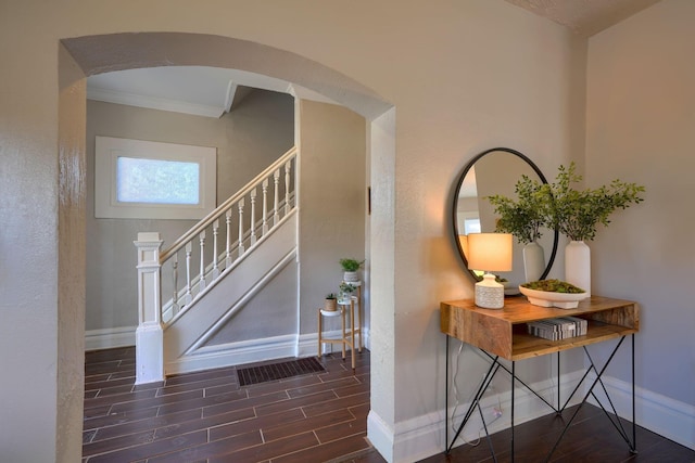 foyer featuring dark hardwood / wood-style flooring and ornamental molding