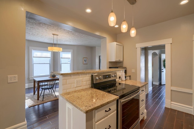 kitchen featuring electric range, dark hardwood / wood-style floors, a textured ceiling, decorative light fixtures, and white cabinetry