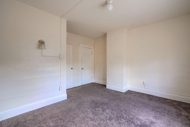 empty room featuring dark colored carpet