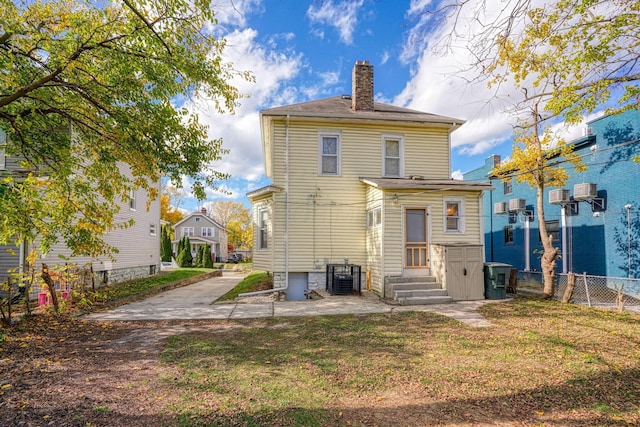 rear view of property featuring central AC