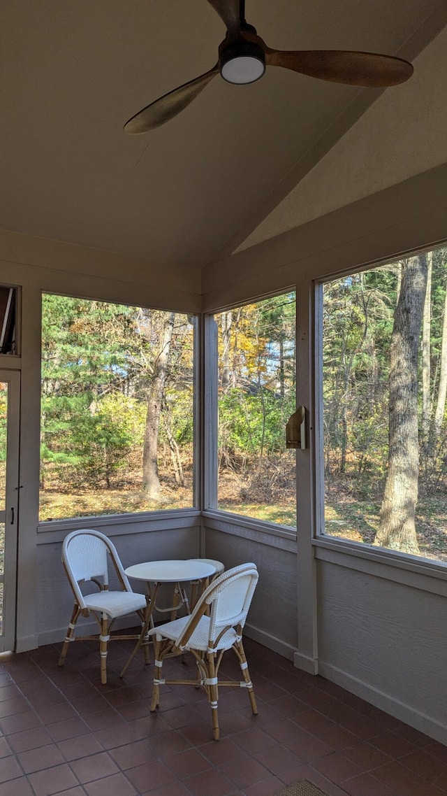 sunroom with ceiling fan and lofted ceiling