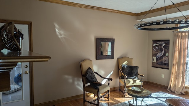 living area with crown molding and hardwood / wood-style floors