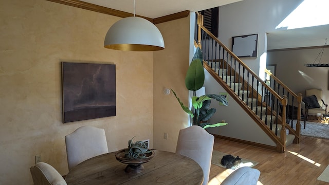 dining room featuring hardwood / wood-style floors and ornamental molding