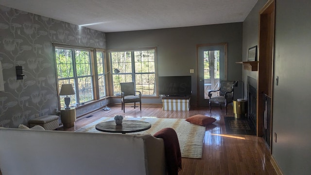 living room featuring hardwood / wood-style floors, plenty of natural light, and a textured ceiling