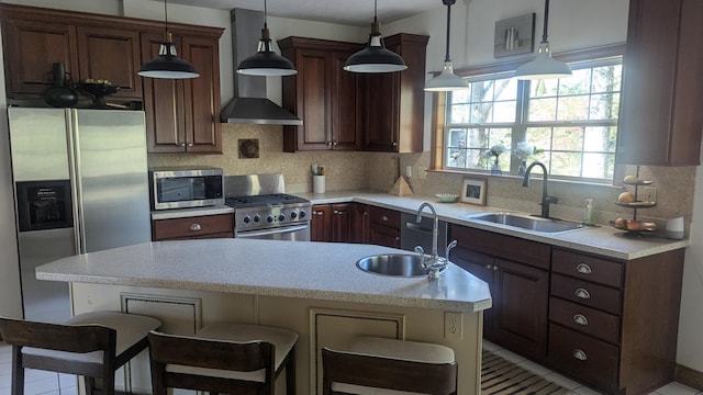 kitchen featuring a kitchen bar, sink, light tile patterned flooring, and appliances with stainless steel finishes