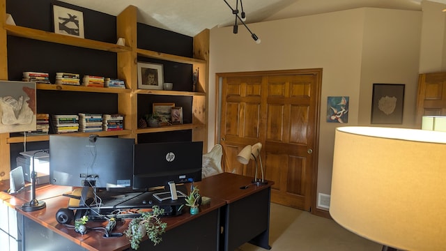 office area with vaulted ceiling