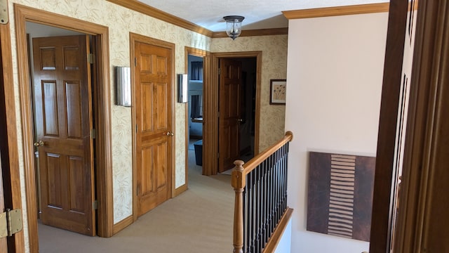 corridor featuring light carpet, a textured ceiling, and ornamental molding